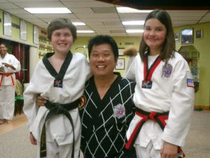Martial arts instructor with two students